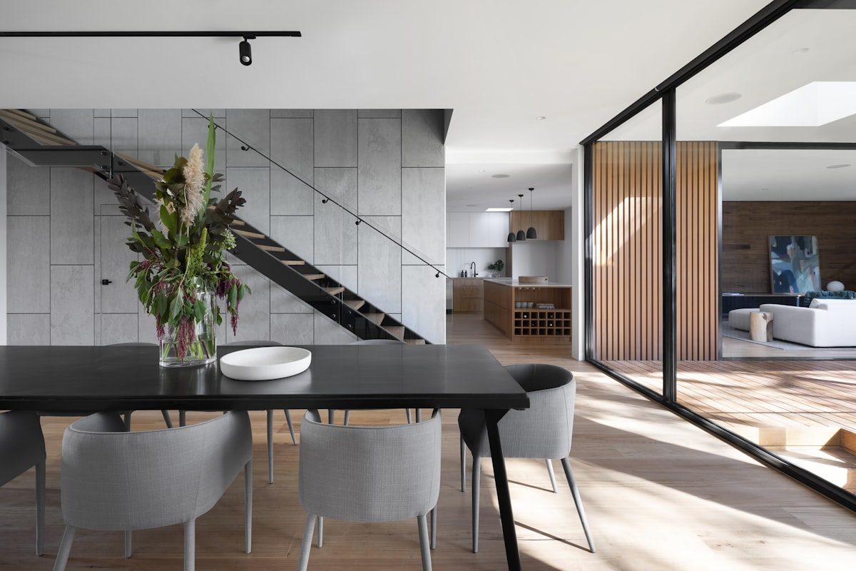 Modern remodeled living space with black-framed windows by Blackstone Remodeling